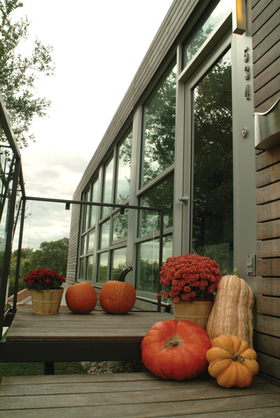 Large platforms, decorated with pumpkins from a local patch, lead to the kitchen entry.